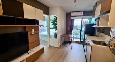 Modern open plan living room with adjacent kitchen