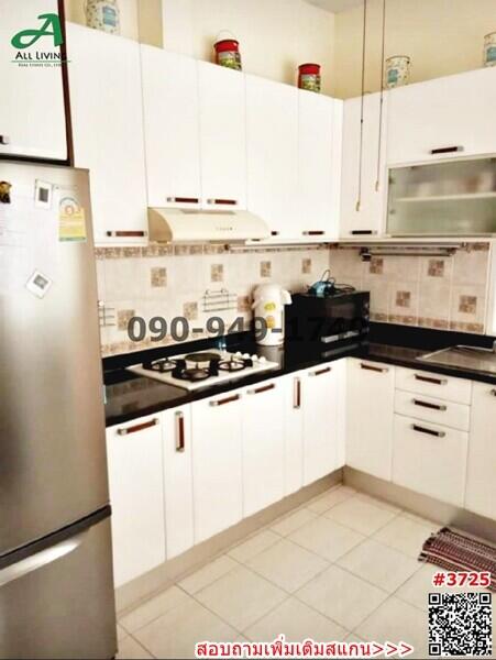 Modern kitchen with stainless steel appliances and white cabinetry