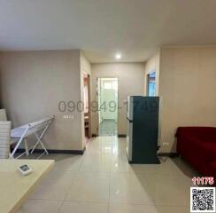 Spacious living room with tiled flooring and a large window