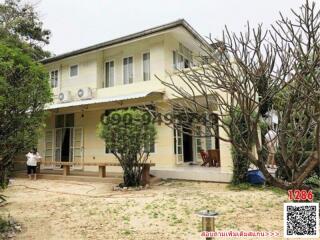 Two-storey house with veranda and garden