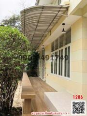 Spacious outdoor patio with awning and seating area