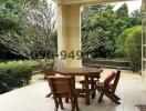 Spacious patio with a wooden table and chairs and a view of the garden