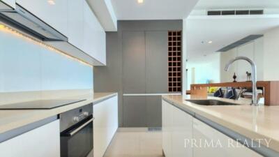 Modern kitchen with stainless steel appliances and white cabinetry in a bright apartment