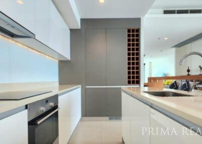Modern kitchen with stainless steel appliances and white cabinetry in a bright apartment