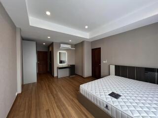 Spacious bedroom with modern design and hardwood flooring