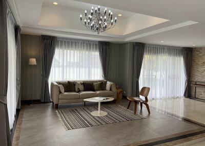 Spacious and elegant living room with modern furnishings and ample natural light