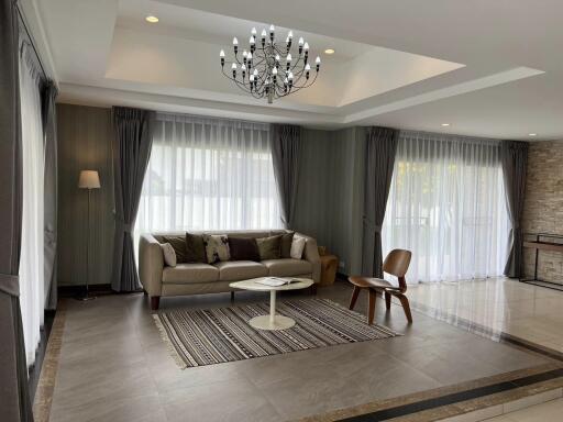 Spacious and elegant living room with modern furnishings and ample natural light