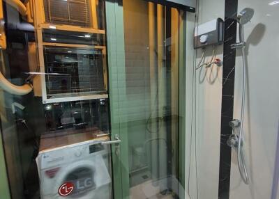 Compact utility room with washing machine and glass partition