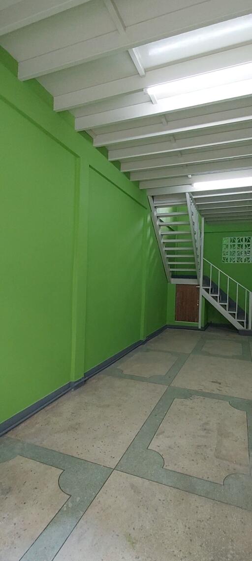 Interior view of a building stairway with green walls