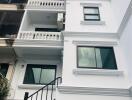 Exterior view of a modern multi-story residential building with balconies and large windows