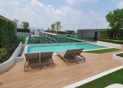 Swimming pool with lounging chairs in an outdoor leisure area