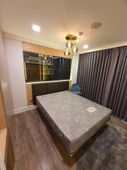 Cozy bedroom with modern lighting and wooden flooring