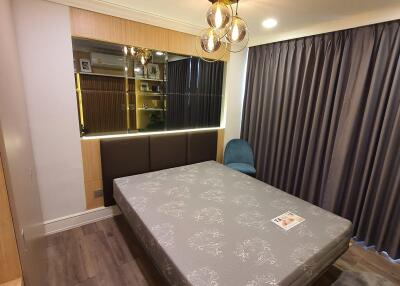 Cozy bedroom with modern lighting and wooden flooring