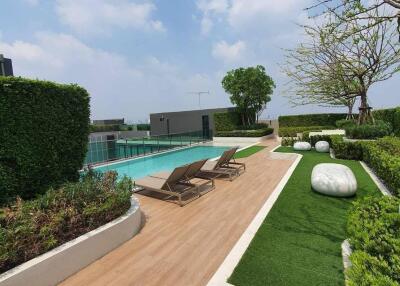 Modern residential outdoor space with swimming pool and lounge chairs