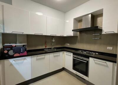 Modern kitchen with white cabinets and stainless steel appliances