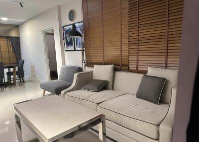 Modern Living Room with L-shaped Sofa and Wooden Blinds