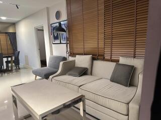Modern Living Room with L-shaped Sofa and Wooden Blinds