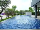 Swimming pool area adjacent to a modern house