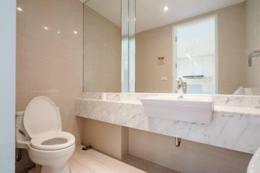 Modern bathroom with marble countertop and large mirror