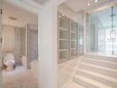 Spacious marble bathroom with glass shower cabin and modern amenities