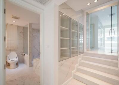Spacious marble bathroom with glass shower cabin and modern amenities