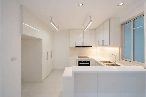 Modern white kitchen with clean design and ample lighting