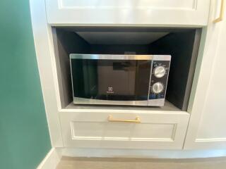 Modern microwave oven in a built-in kitchen cabinet