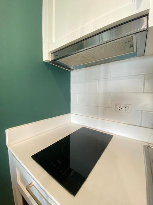 Modern kitchen with induction cooktop and range hood