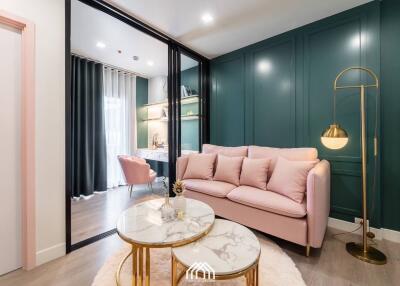 Modern living room with pink sofa and gold accent coffee tables