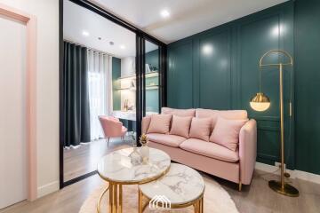 Modern living room with pink sofa and gold accent coffee tables