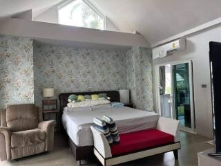 Elegant bedroom with high ceiling and decorative wallpaper
