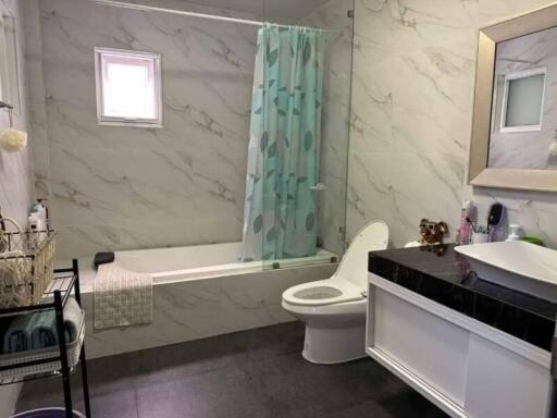Modern bathroom with marble tiles and tub