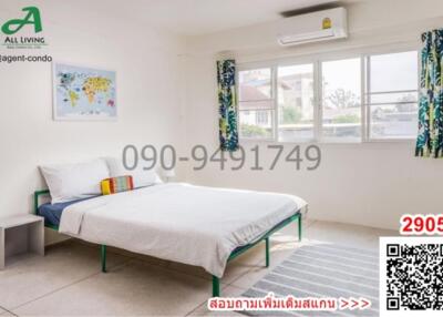 Spacious and well-lit bedroom with a large window and air conditioning unit