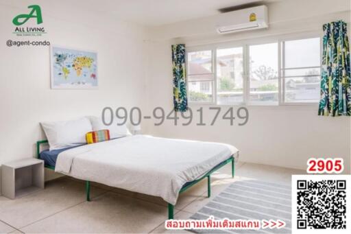 Spacious and well-lit bedroom with a large window and air conditioning unit