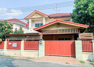 Exterior view of a residential house with a red fence