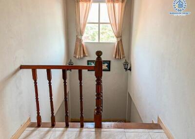 Cozy hallway with wooden railing and natural light