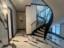 Elegant entrance hall with marble floors and a modern staircase