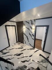 Modern hallway interior with marble floors and chic lighting