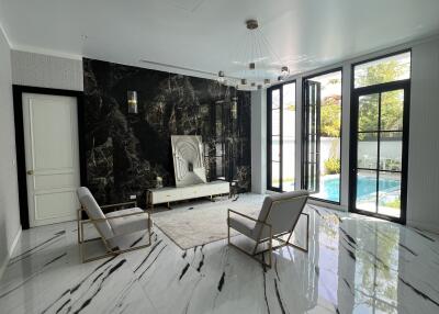 Modern living room with marble floors and pool view