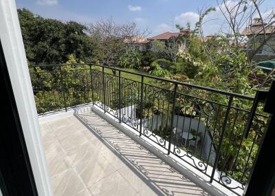 Spacious balcony with a view of trees and clear skies