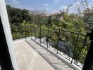 Spacious balcony with a view of trees and clear skies