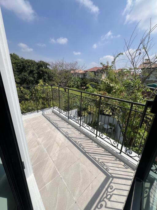 Spacious balcony with a view of trees and clear skies