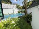 Cozy backyard with a swimming pool and lush greenery