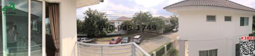 Panoramic view from a balcony overlooking the neighborhood with multiple houses and parked cars