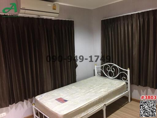 Spacious bedroom with air conditioning and large curtains