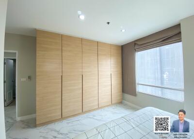 Spacious bedroom with large wardrobe and natural light
