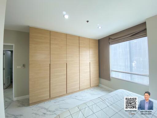 Spacious bedroom with large wardrobe and natural light