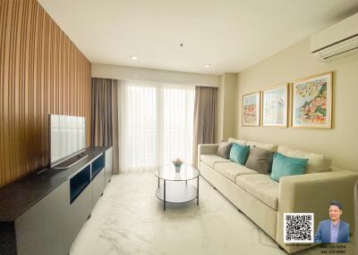 Modern living room with a sofa, coffee table, and television