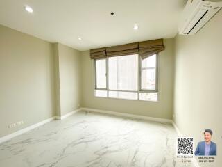 Spacious and bright empty room with large windows and marble flooring