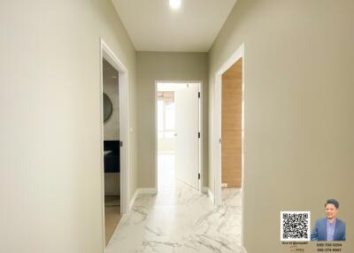 Well-lit hallway with marble flooring